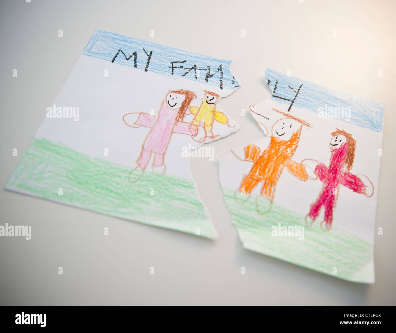 Torn child's drawing depicting family Stock Photo