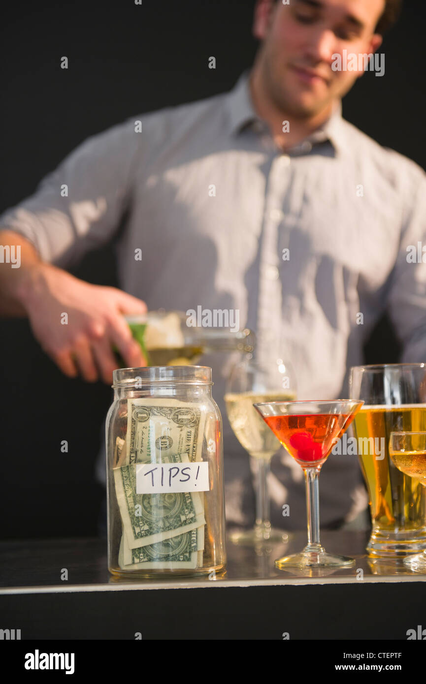 USA, New Jersey, Jersey City, Bar tender pouring wine into glass Stock Photo