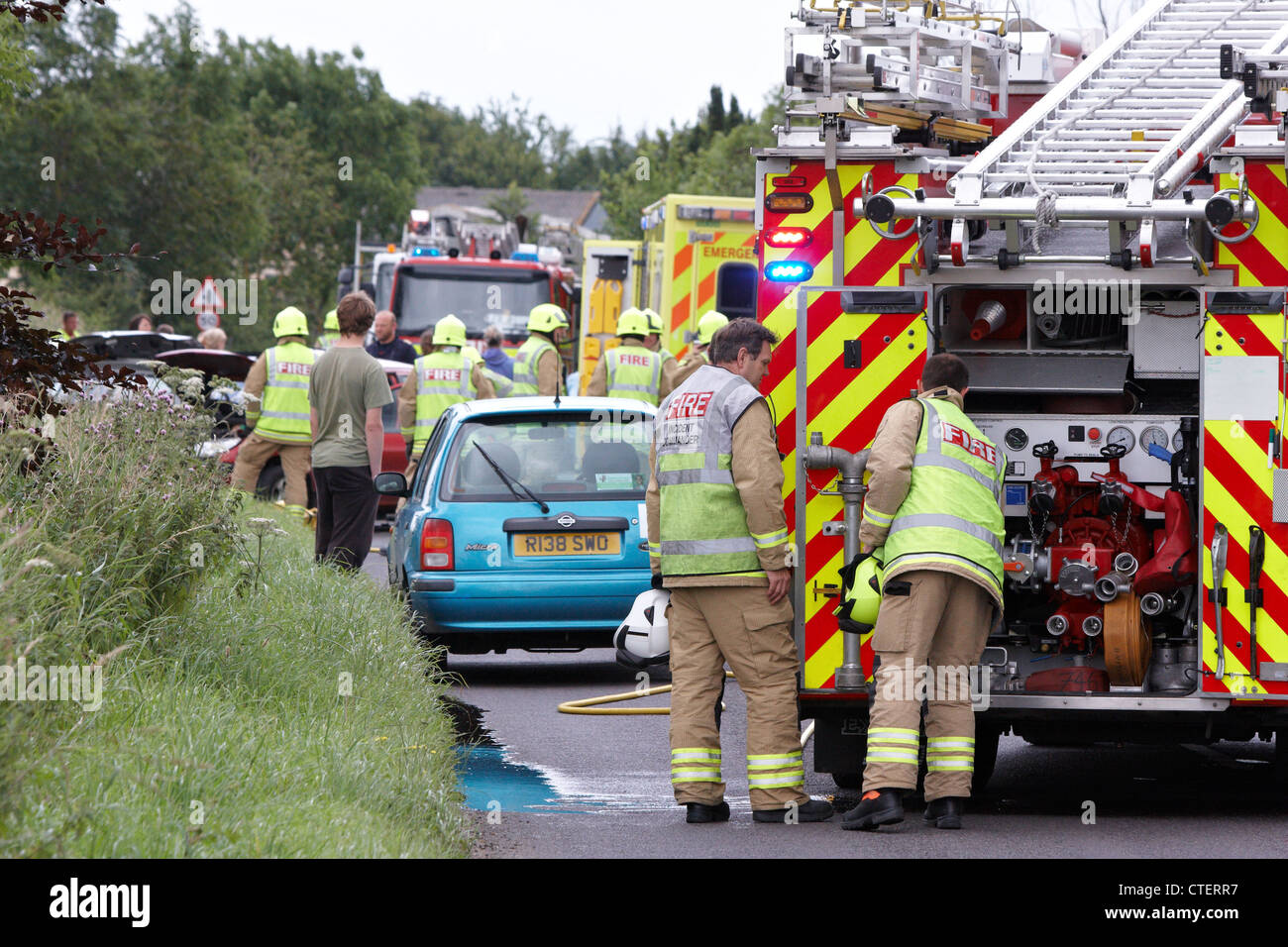 Emergency services deal with a road traffic accident involving two cars ...