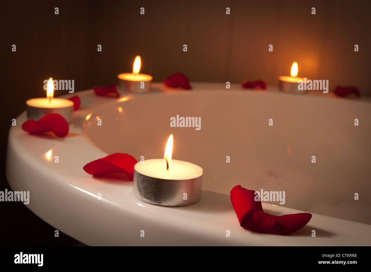 Candles and Rose petals around a bubble bath Stock Photo - Alamy