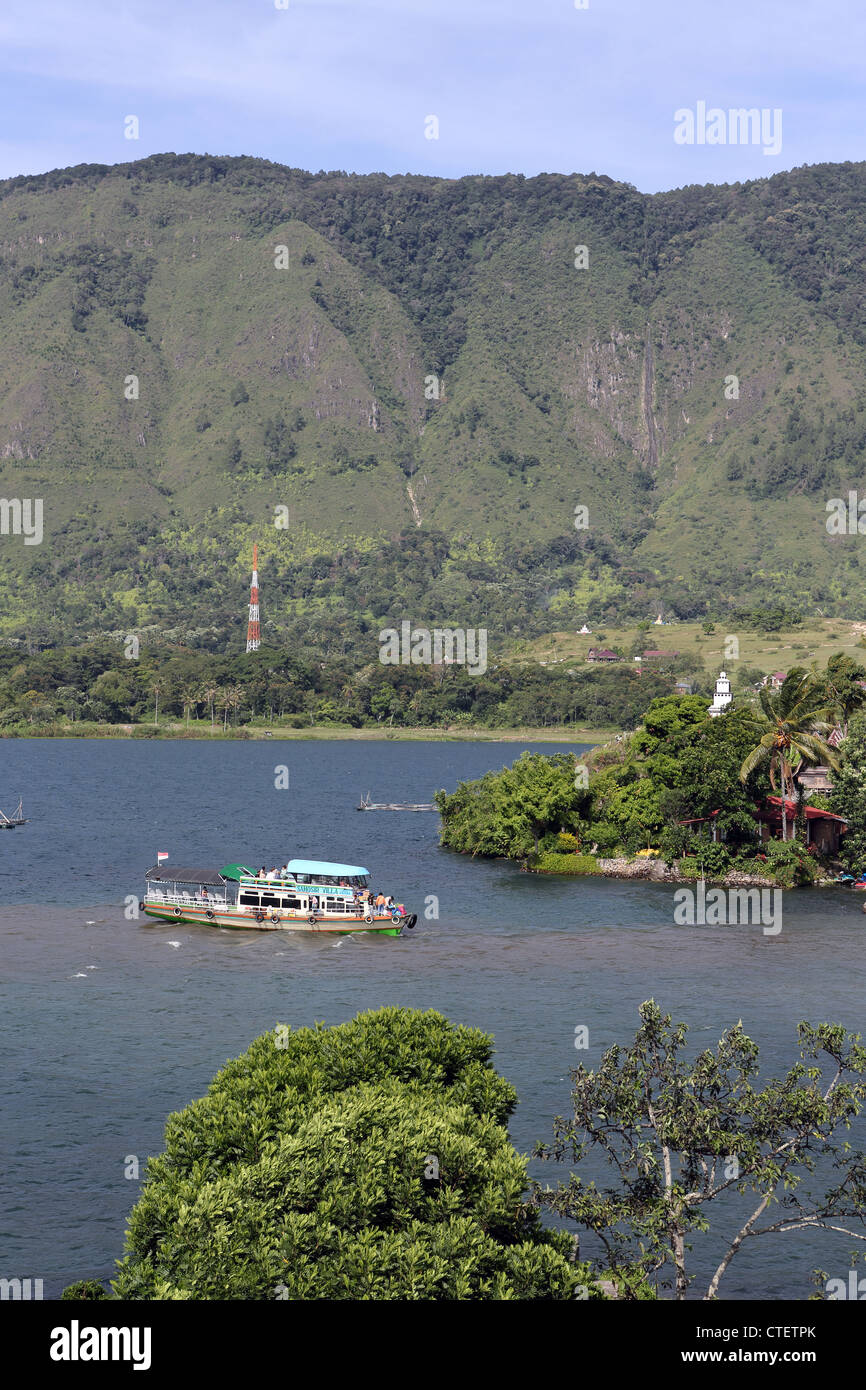 Wooden passenger ferry departing for Parapat from Bagus Bay, on Samosir Island, Lake Toba. Stock Photo