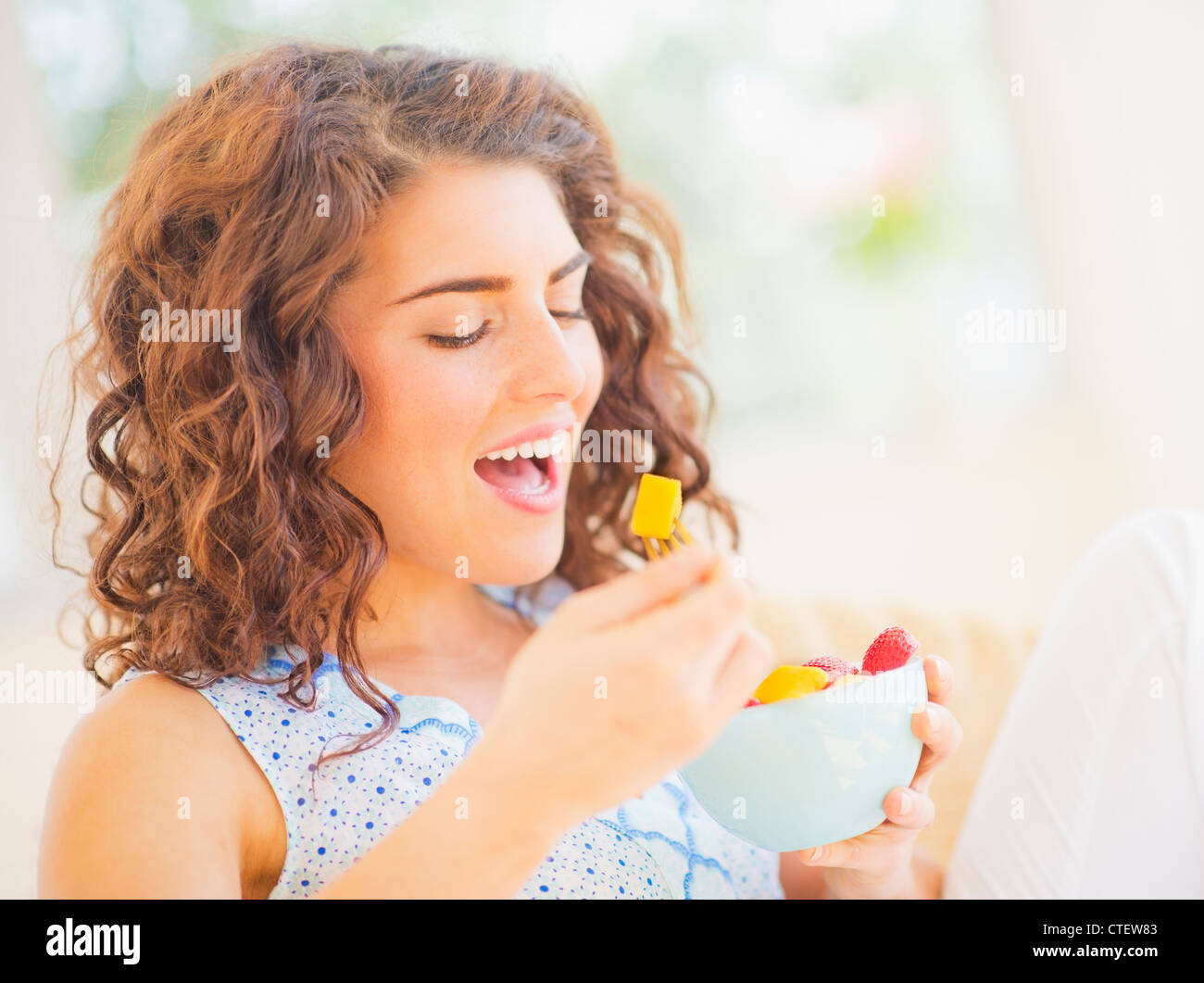 USA, New Jersey, Jersey City, Portrait of woman eating fruit salad Stock Photo