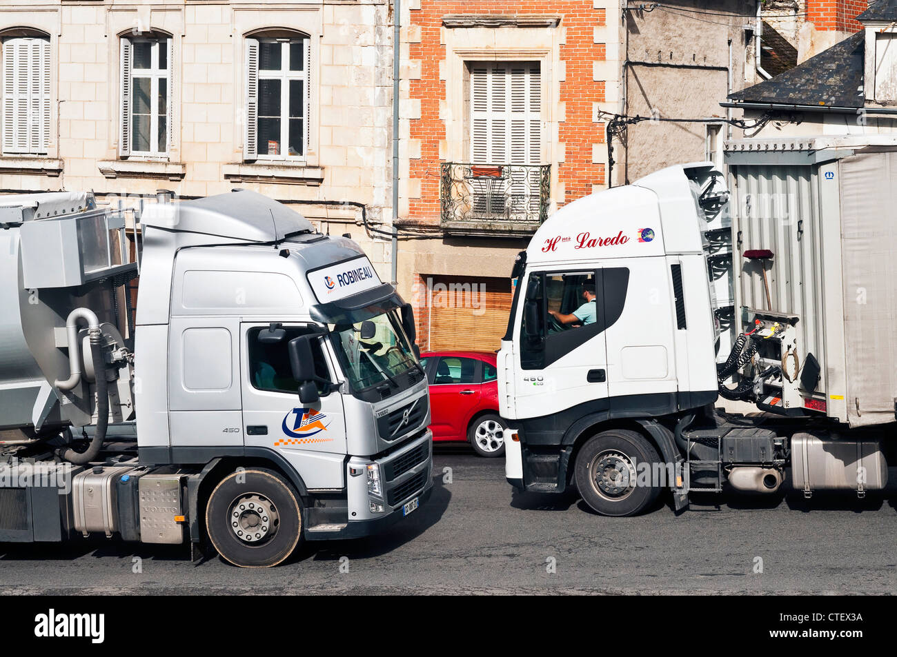 Heavy Goods Vehicles in town traffic - France. Stock Photo