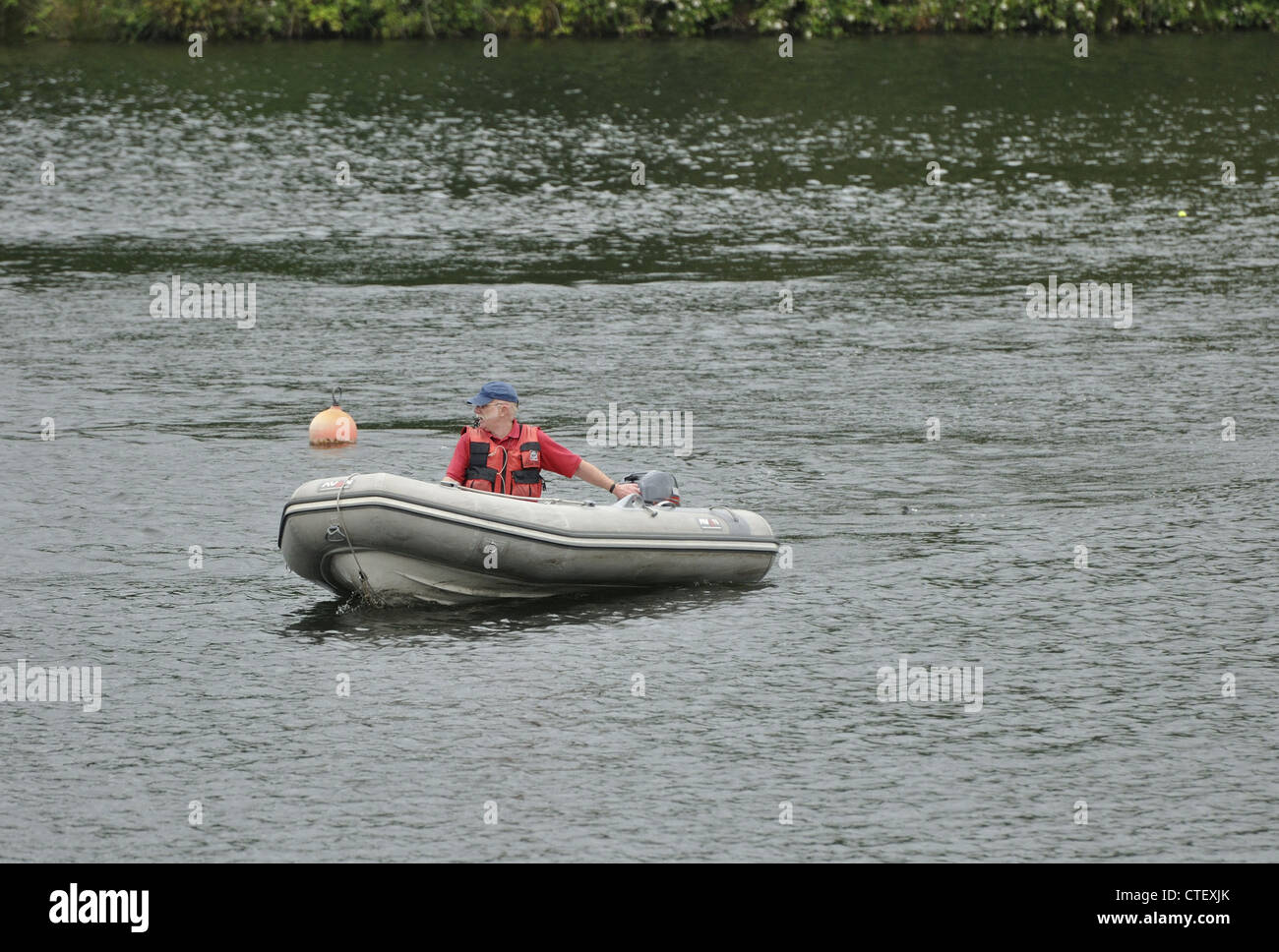 Grey rubber dinghy with outboard motor on Debdale Park Lower reservoir