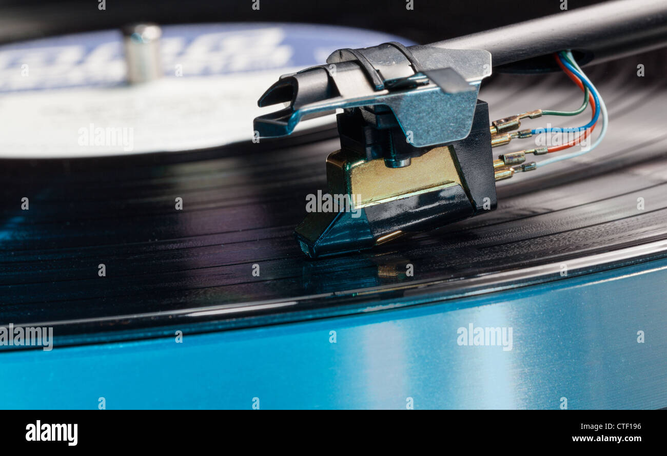 Long Playing record LP on retro record player with tone arm and cartridge Stock Photo