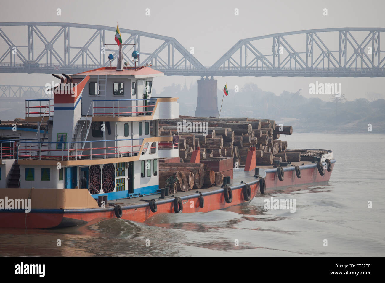 Barge hauling logs down the Irrawaddy River near Mandalay, Myanmar Stock Photo
