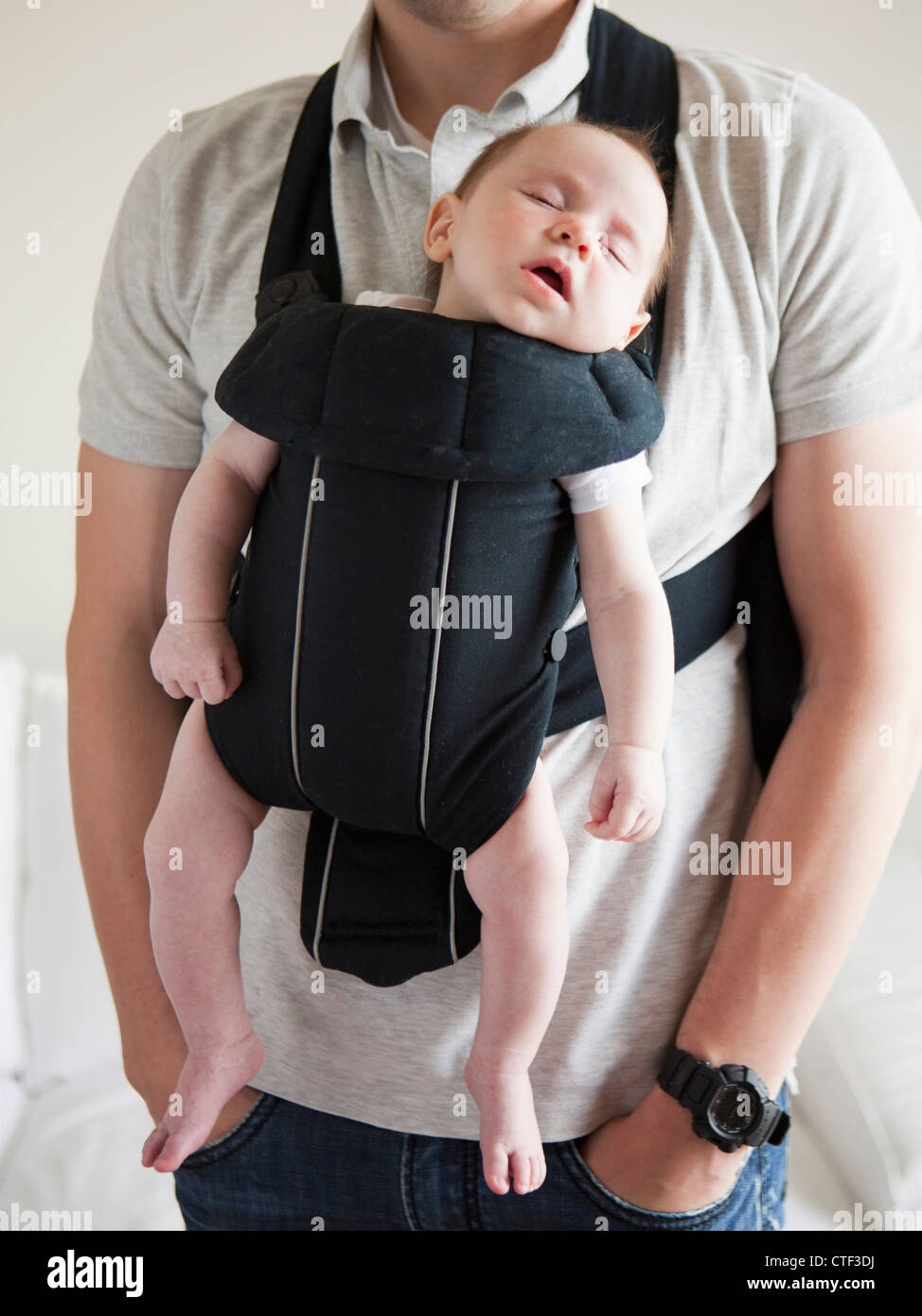Young father holding baby daughter (23 months) in carrycot Stock Photo Alamy