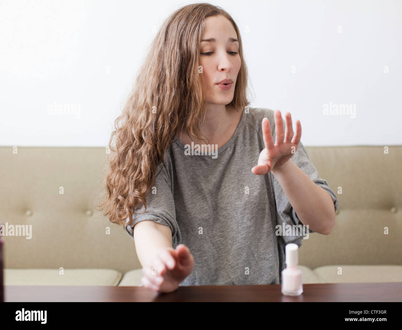USA, Utah, Salt Lake City, Young woman painting fingernails Stock Photo