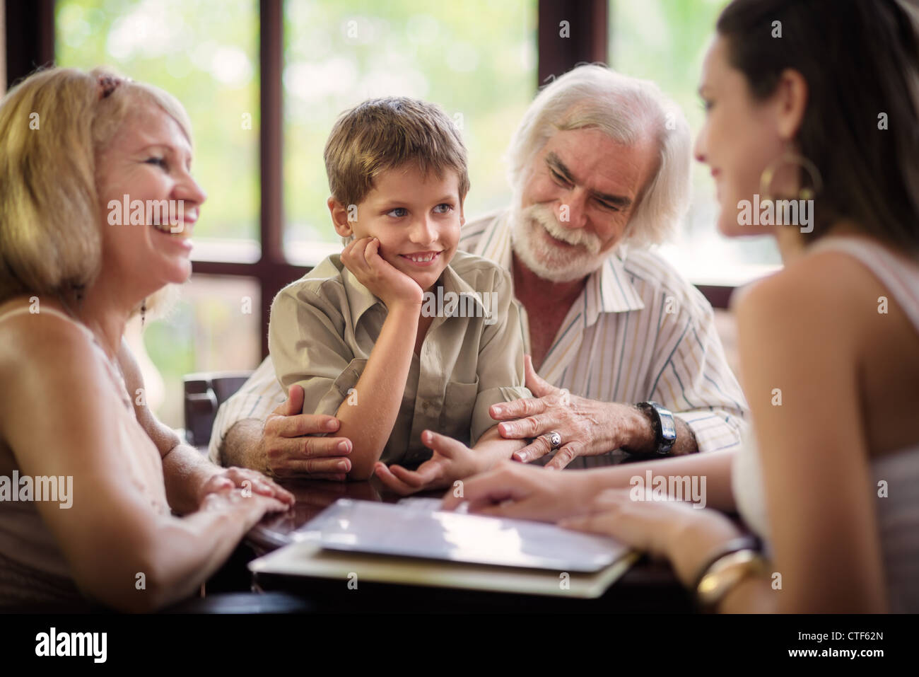 Happy family with husband, wife, child, grandfather and grandmother