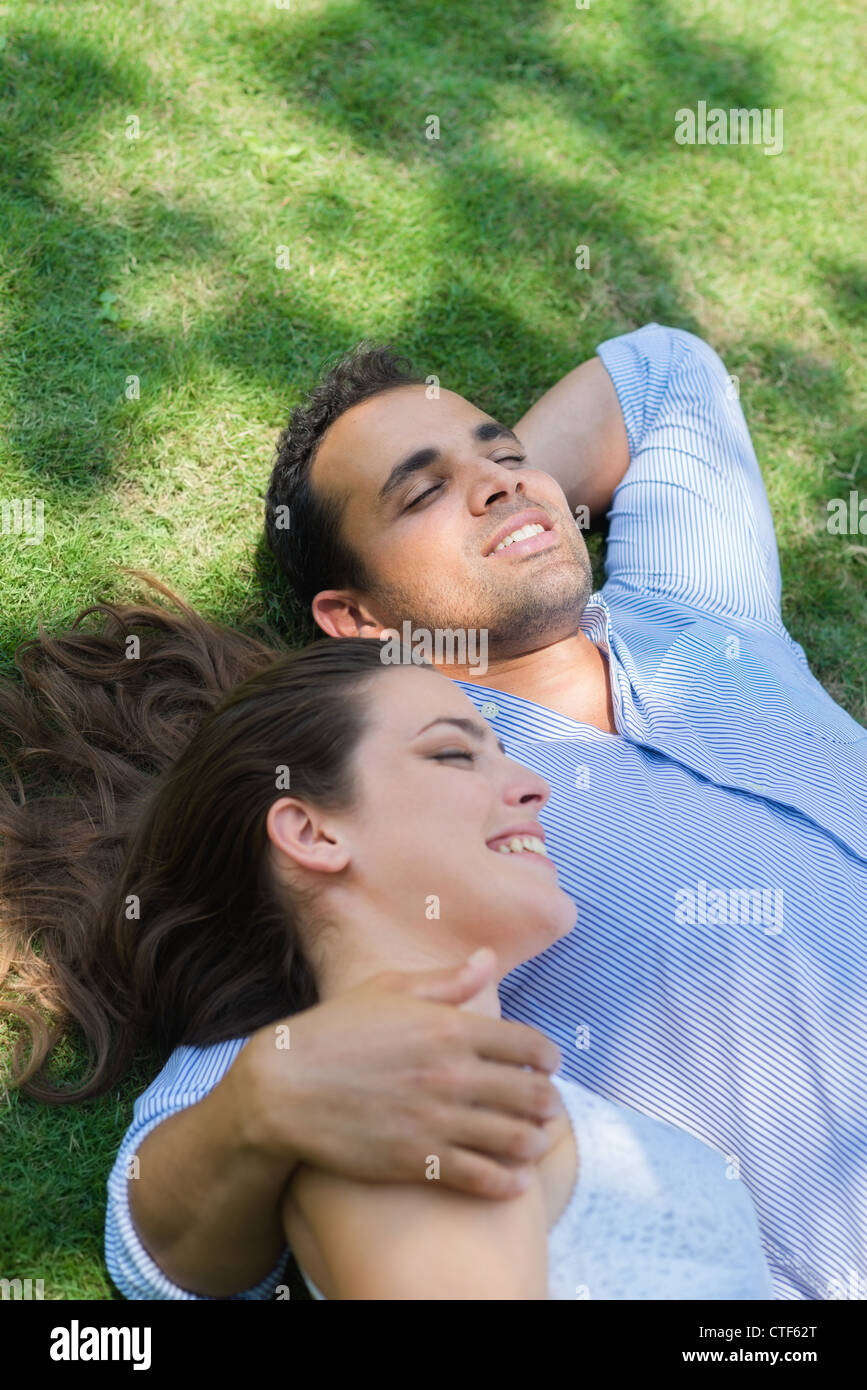 https://c8.alamy.com/comp/CTF62T/happy-beautiful-young-man-and-woman-in-love-lying-on-grass-in-park-CTF62T.jpg