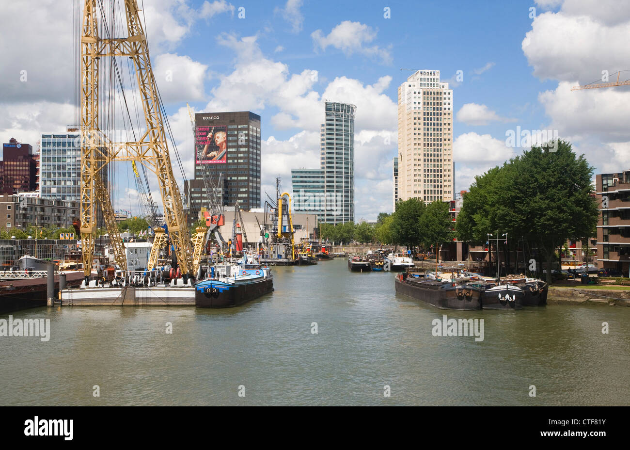 Historic boats modern high rise architecture Haven harbour museum Rotterdam Netherlands Stock Photo