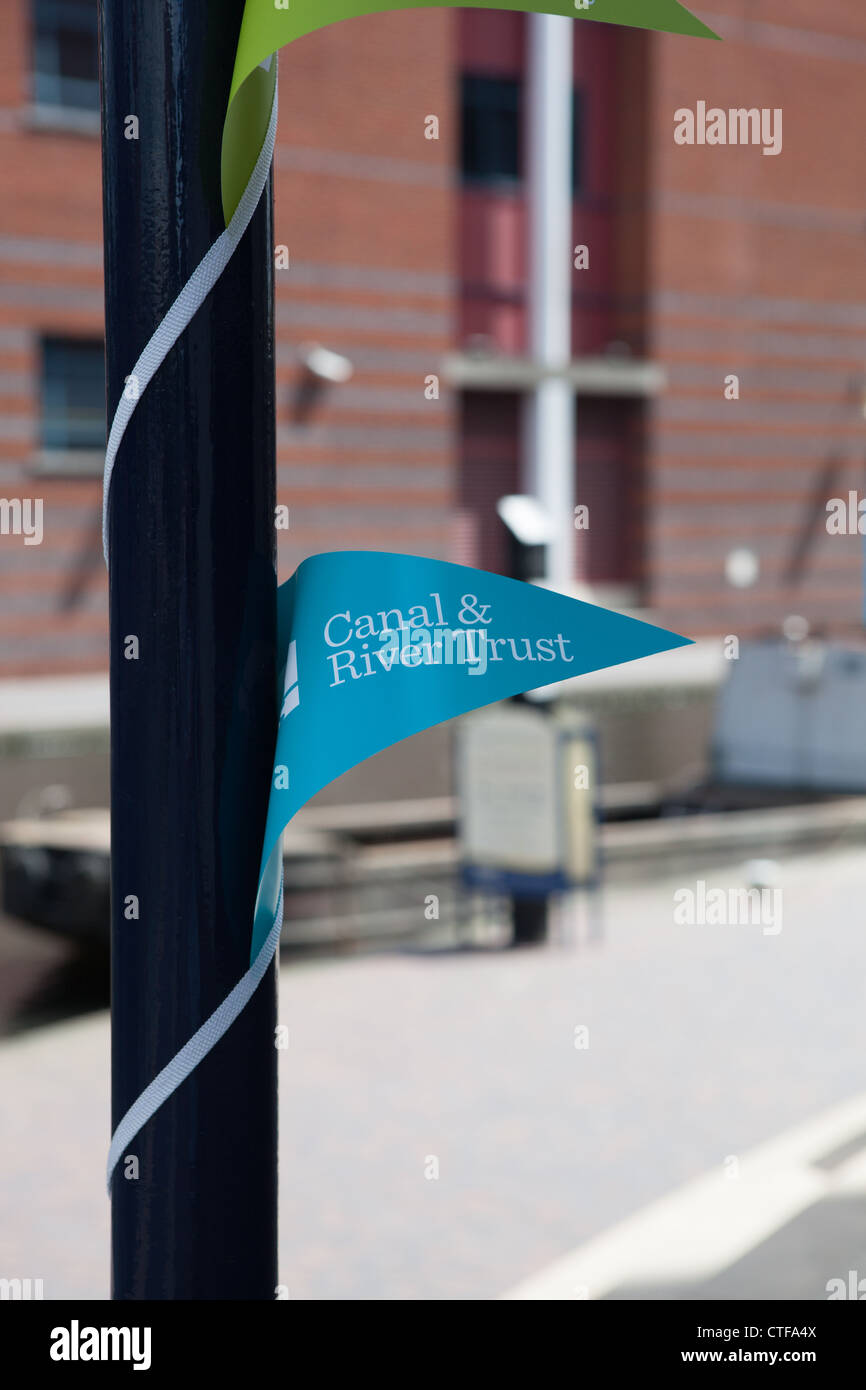 Canal and River Trust pennants wrapped around a post on the side of the canal in Birmingham. Stock Photo