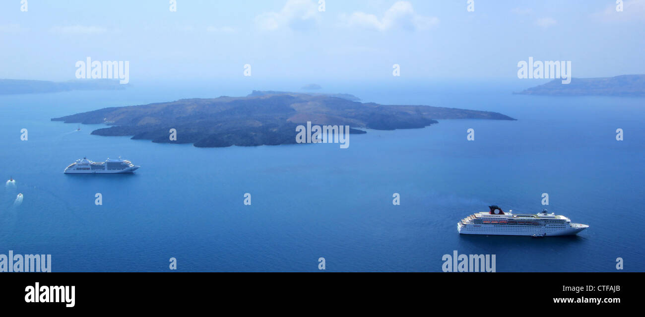 View on Santorini volcano and two cruise ships in the middle of Aegean sea, Cyclades, Greece, by beautiful weather Stock Photo