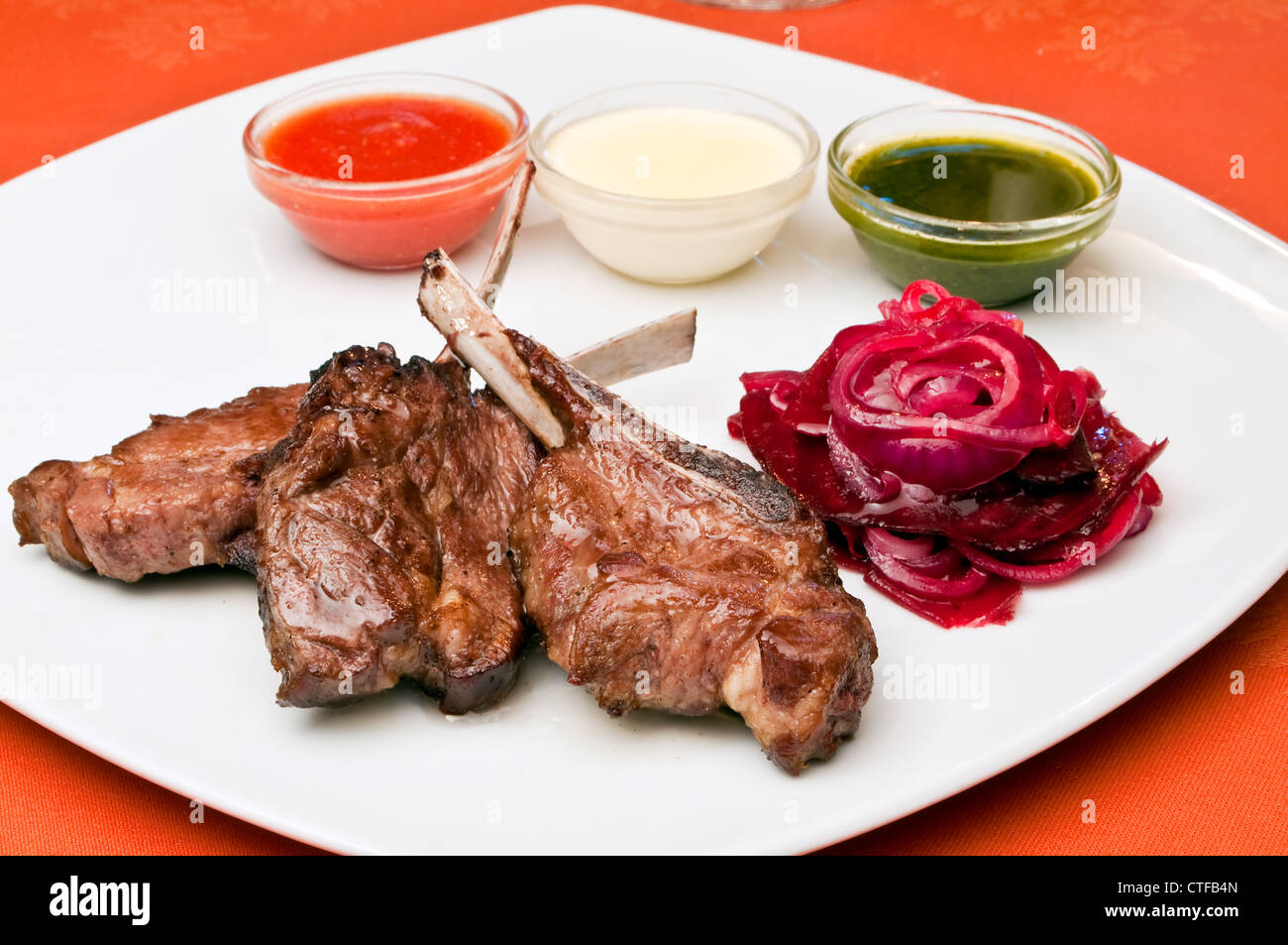 Grilled lamb ribs with three-color sauce Stock Photo