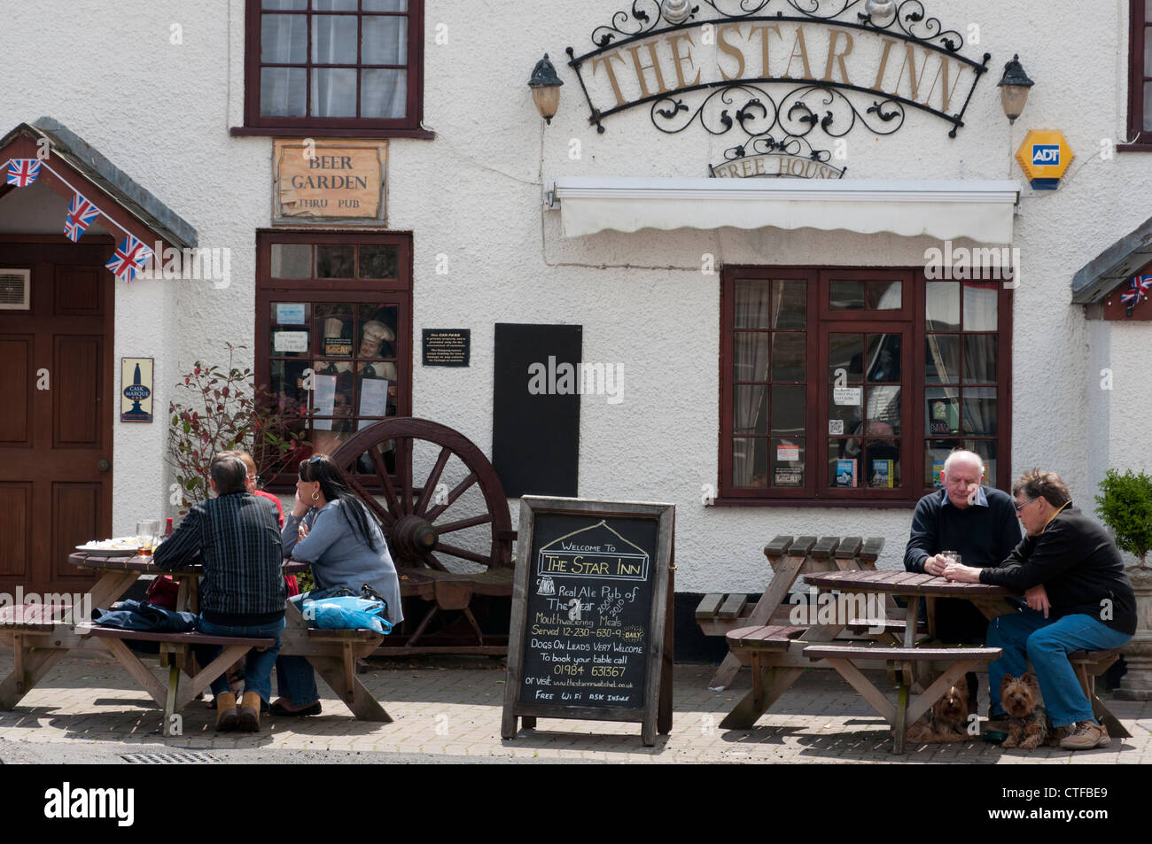 People drinking outside the Star Inn pub in Watchet, West Somerset Stock Photo