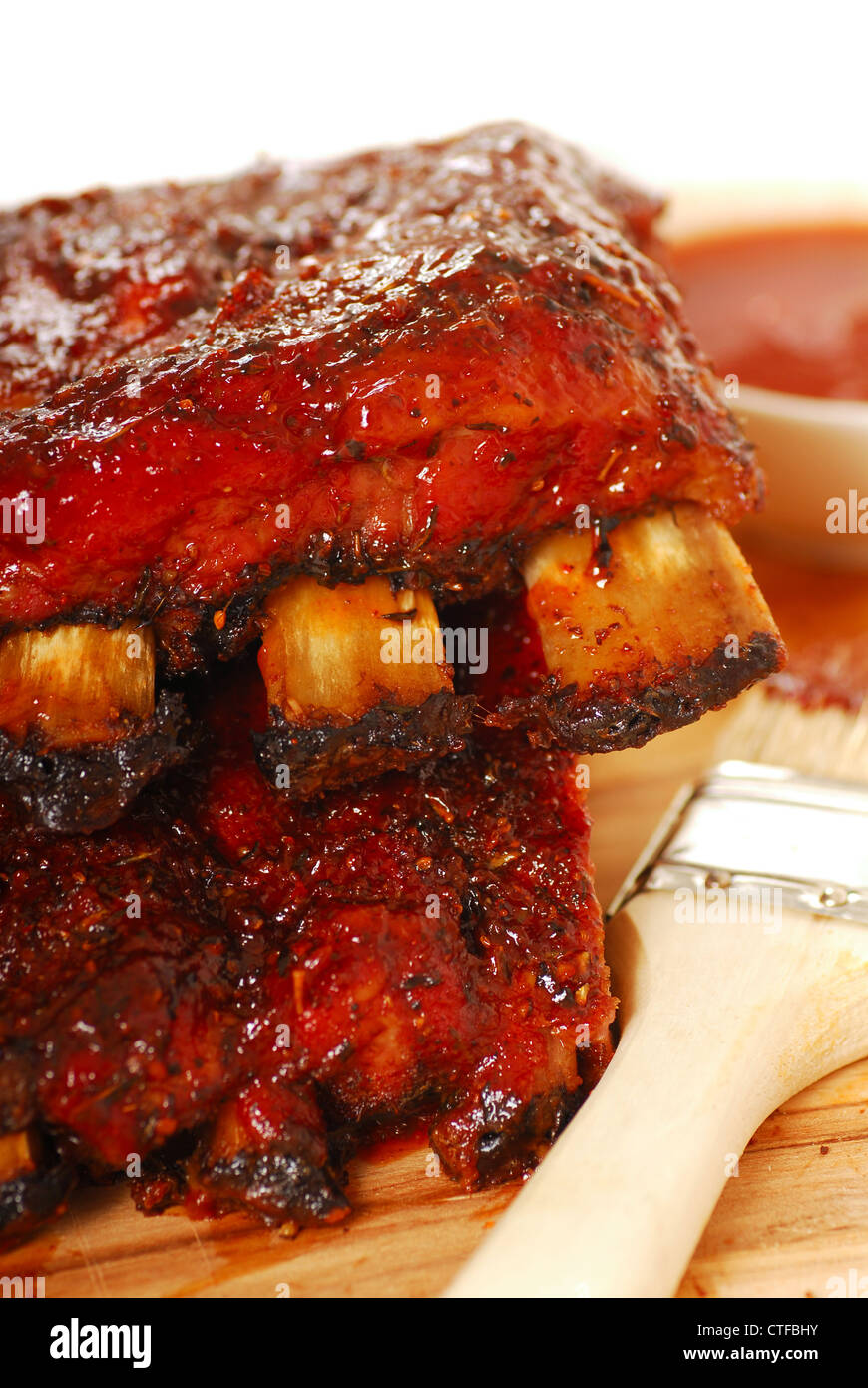 Two slabs of BBQ spare ribs with dipping sauce Stock Photo Alamy