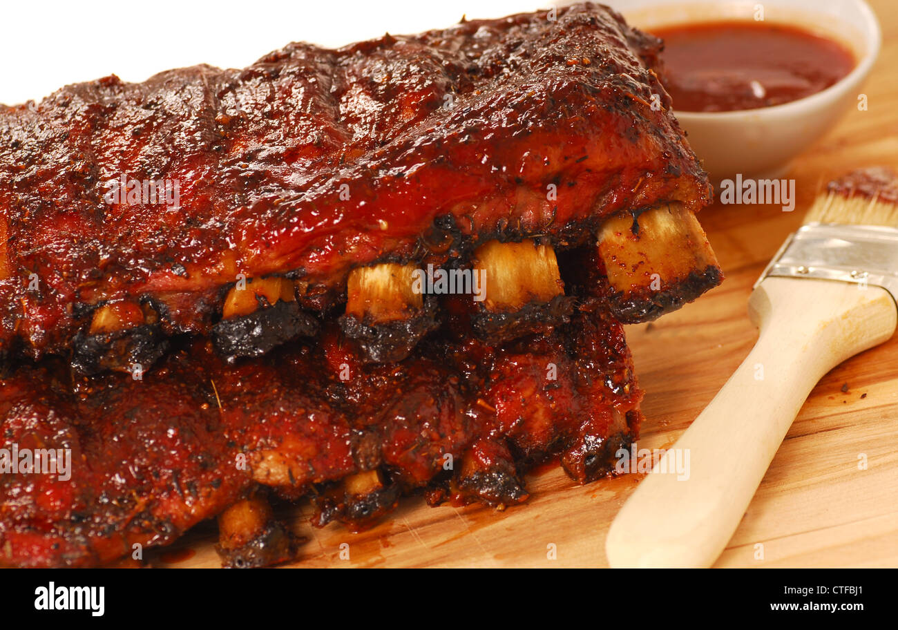 Two slabs of delicious BBQ spare ribs with dipping sauce Stock Photo