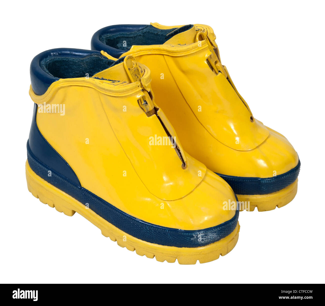 Yellow rubber boots to be worn on the feet to keep them dry path
