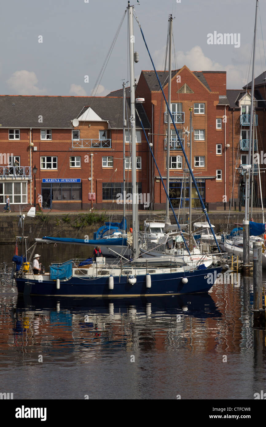 A sailing yacht heads out of Swansea Marina Stock Photo Alamy