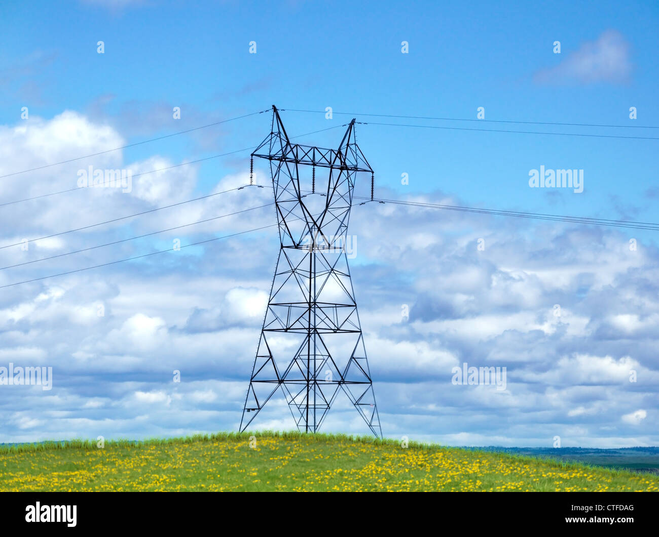 Power Tower On A Hill Against A Blue Sky Stock Photo