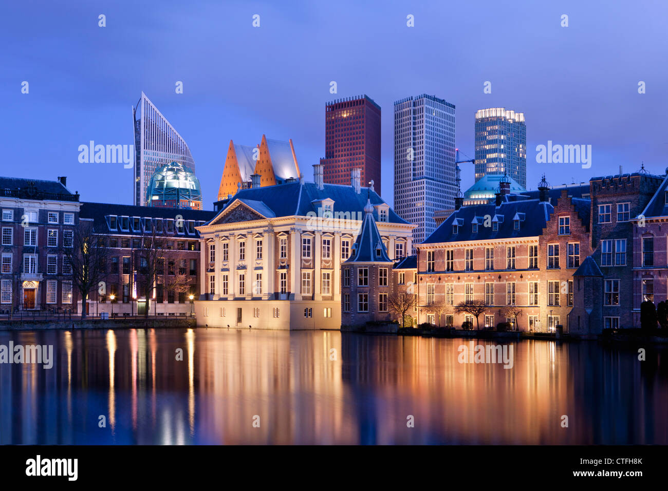 Netherlands, Group of buildings called Binnenhof, center of Dutch politics. In the middle museum called Mauritshuis. Dusk. Stock Photo