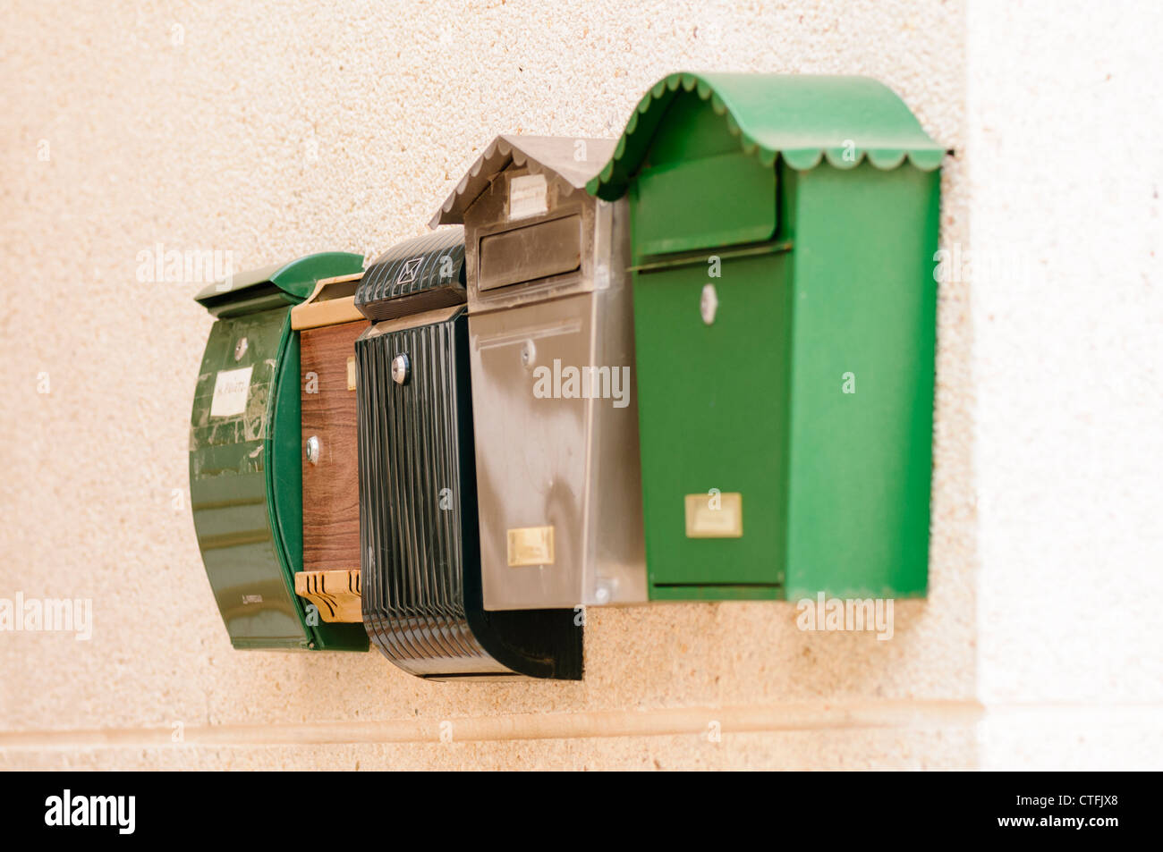 Row of letterboxes on a wall Stock Photo