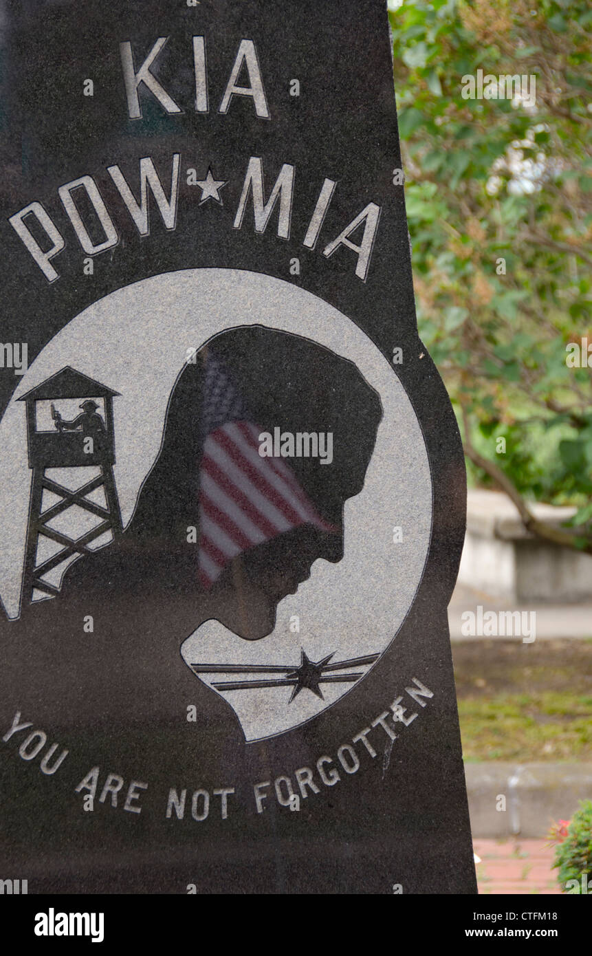 New York, Oswego. Waterfront war memorial with POW / MIA monument, flag reflected in stone. Stock Photo