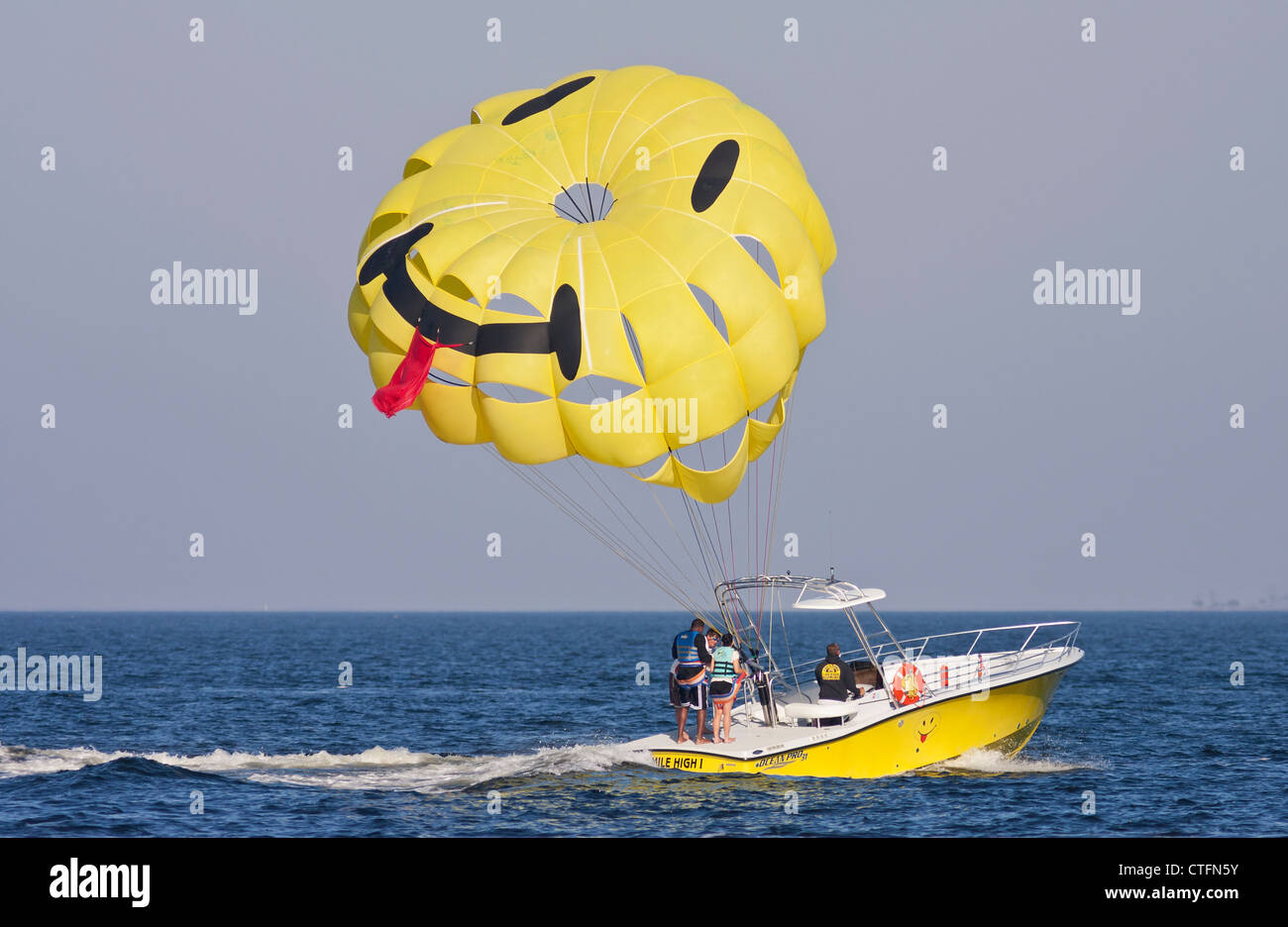 Parasail couple standing on the towboat after finishing their parasail ride in Pensacola Beach, Florida Stock Photo