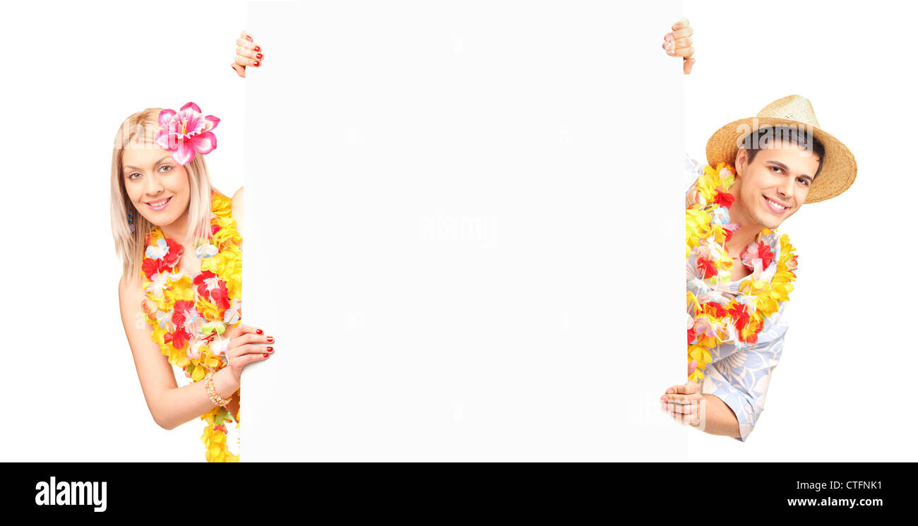 Young male and female wearing flower lei and holding a white panel Stock Photo