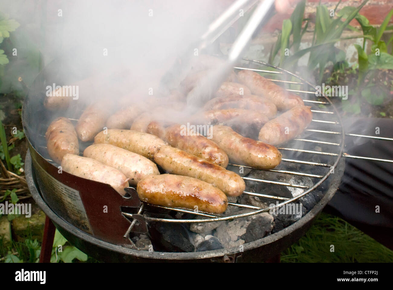meat grilling on the barbecue in garden Stock Photo - Alamy