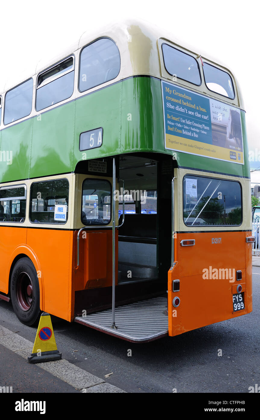 A Daimler double decker bus with open platform in Glasgow Corporation colours in Scotland, UK. Stock Photo