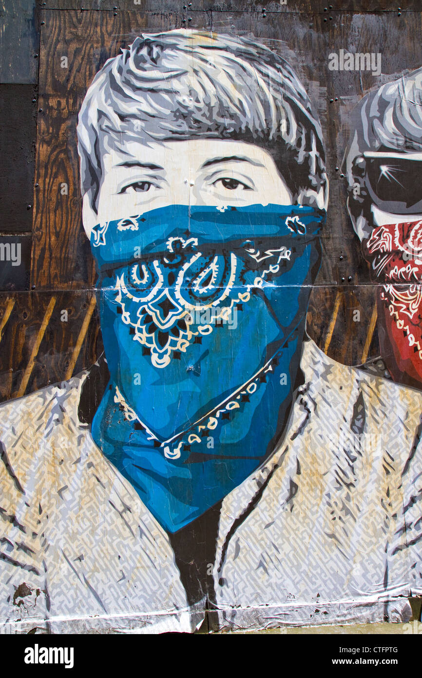Paste-up by street artist Mr Brainwash in London depicting Paul McCartney of The Beatles wearing an outlaw mask. Stock Photo