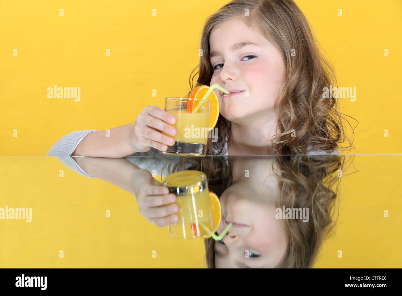 little girl drinking orange juice Stock Photo - Alamy