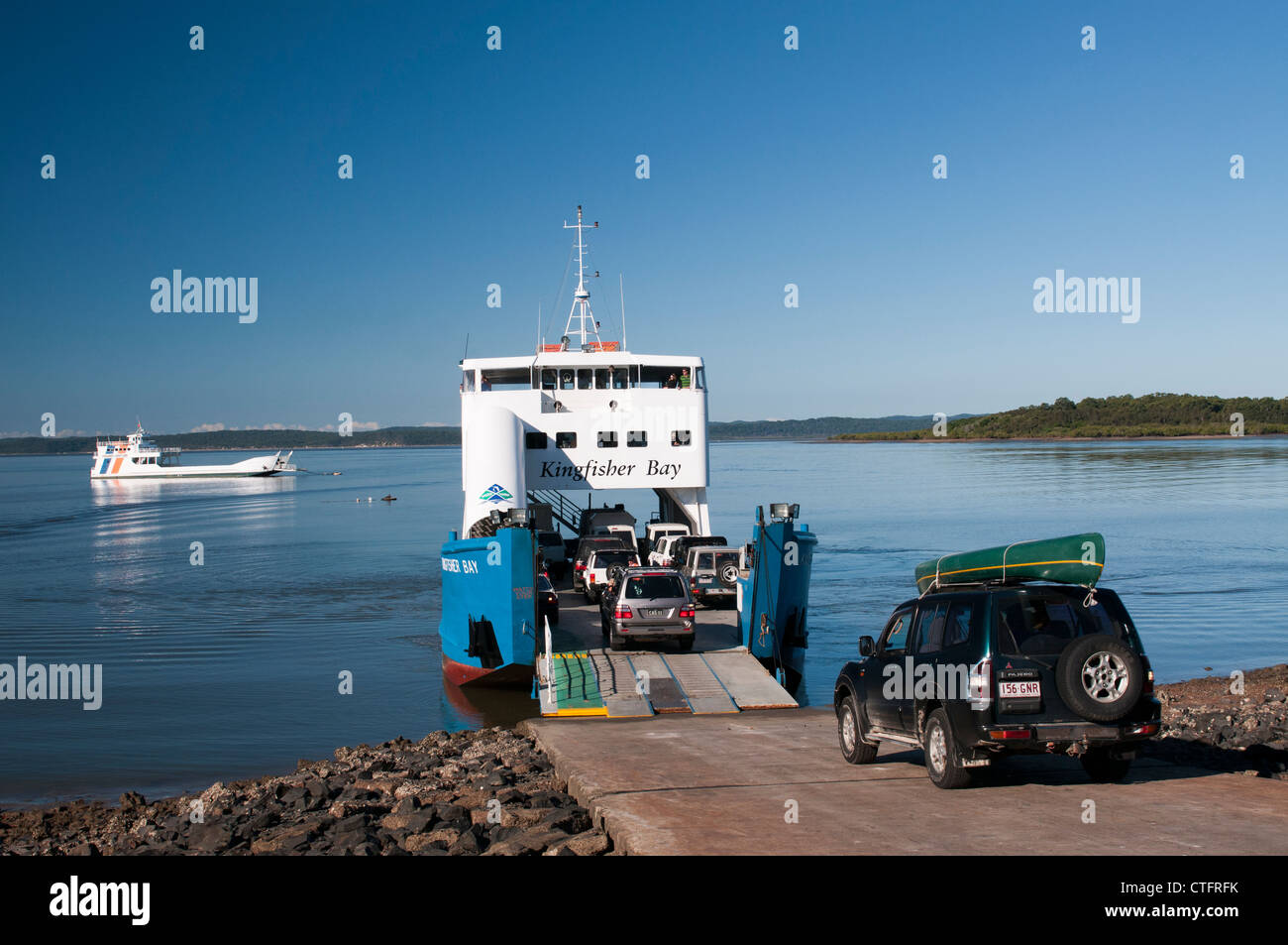 Cars board a ferry, the only way to get to Fraser Island. Stock Photo
