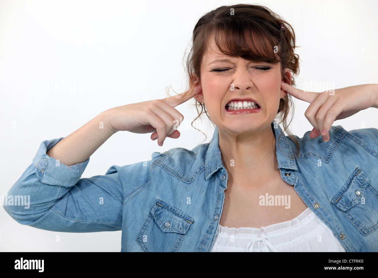 Woman covering her ears Stock Photo Alamy