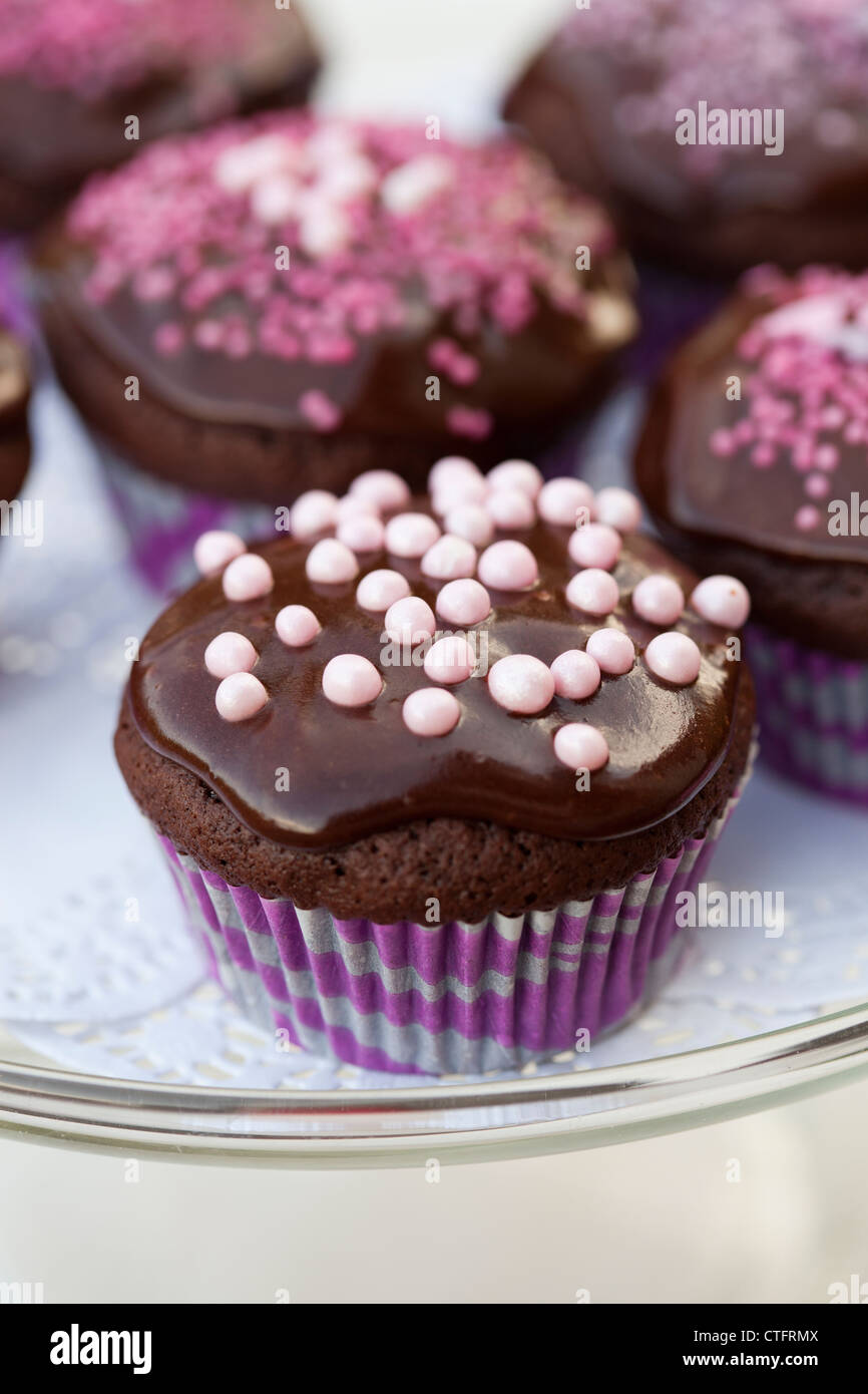 Close-up of delicious chocolate cupcakes with chocolate icing and sprinkles Stock Photo