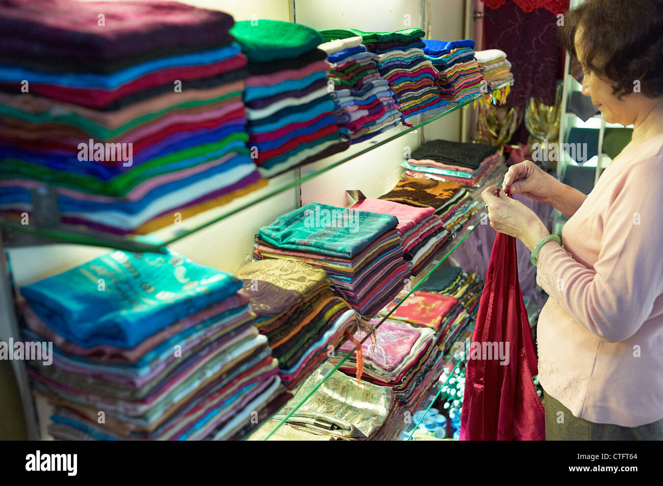 Shop owner shows off silk hires stock photography and images Alamy