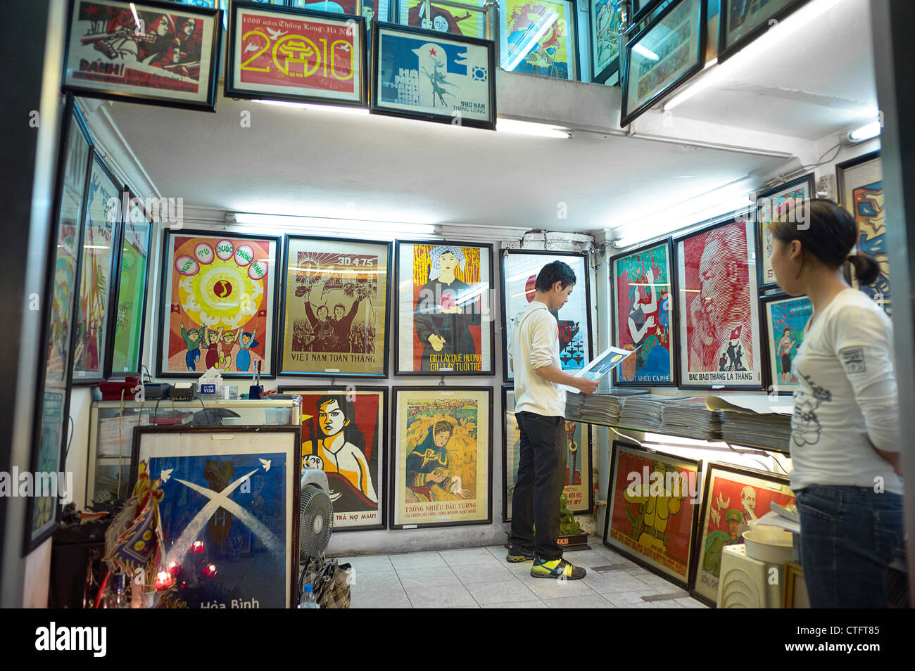 A twostory propaganda poster shop in Vietnam with people browsing