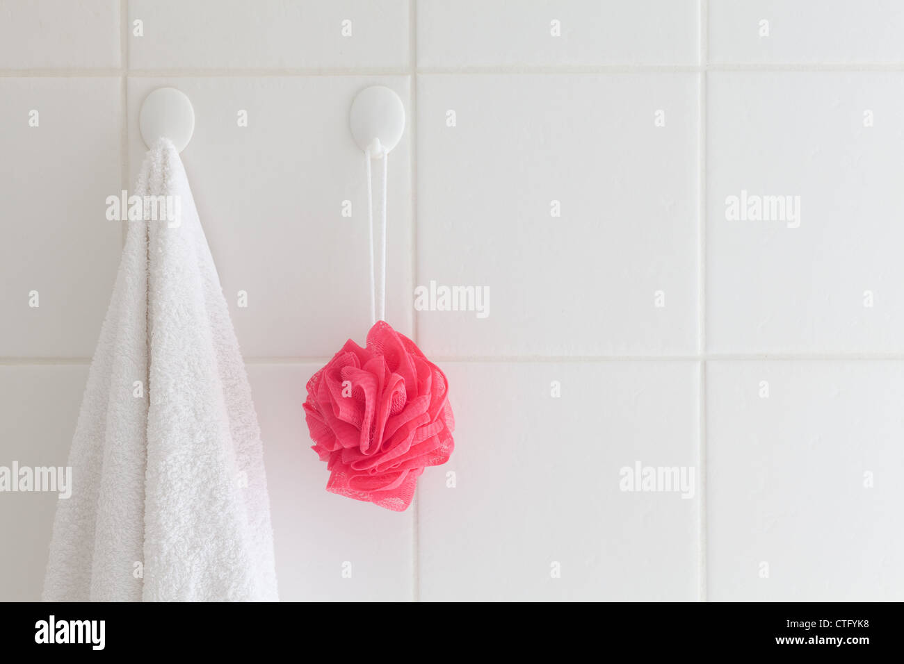 attached,bathroom,ceramic,clean,facecloth,grout,grouted,home,hooks,plastic,red,shower,square,strings,tiles,towel,wall,white Stock Photo