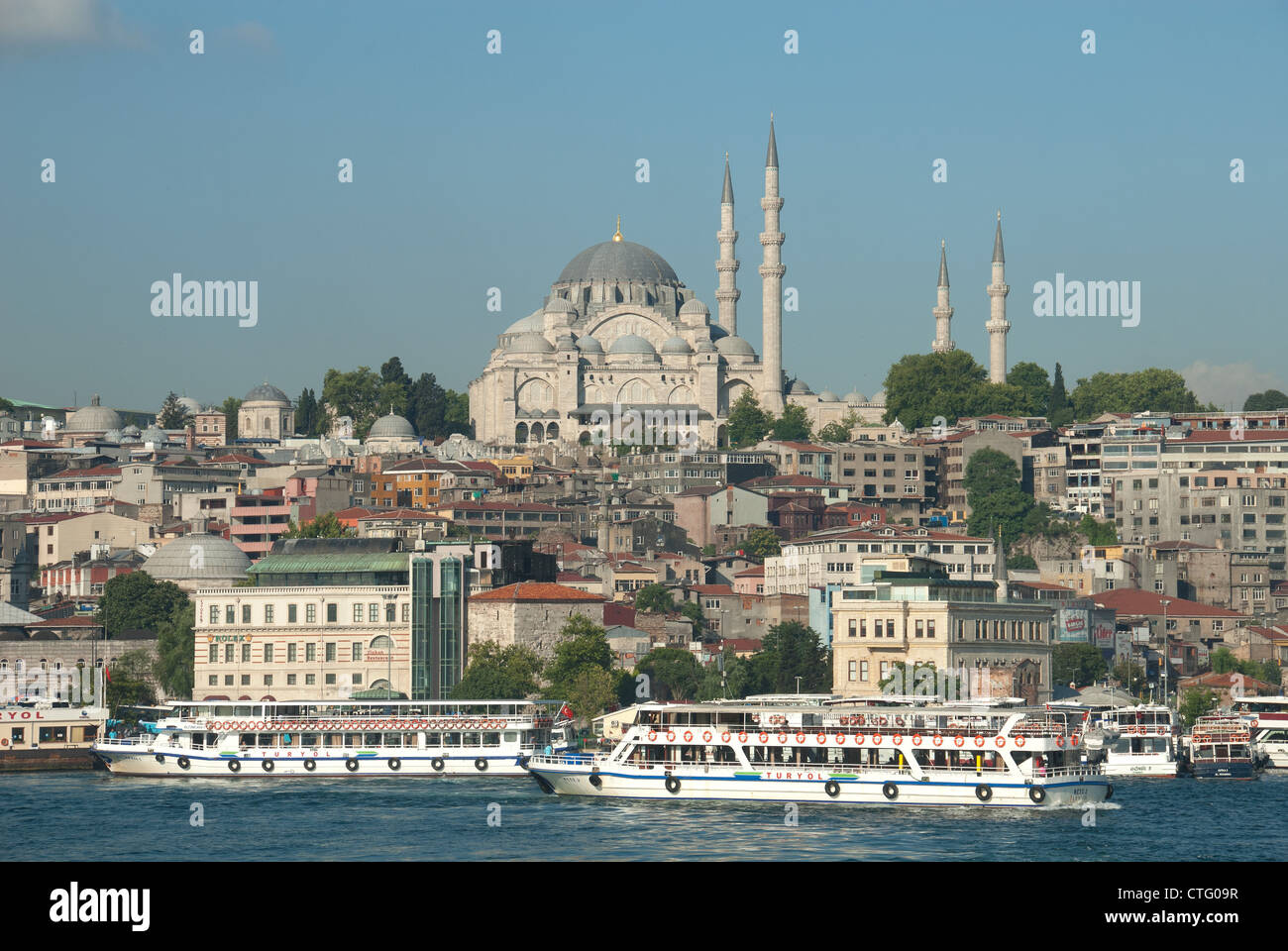 ISTANBUL, TURKEY. Bosphorus ferries on the Golden Horn, with the Suleymaniye mosque dominating the skyline. 2012. Stock Photo