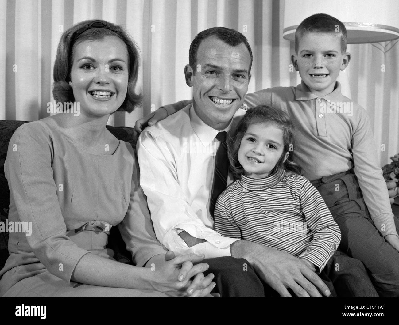 1960s SMILING FAMILY PORTRAIT MOTHER FATHER SON DAUGHTER LOOKING AT ...