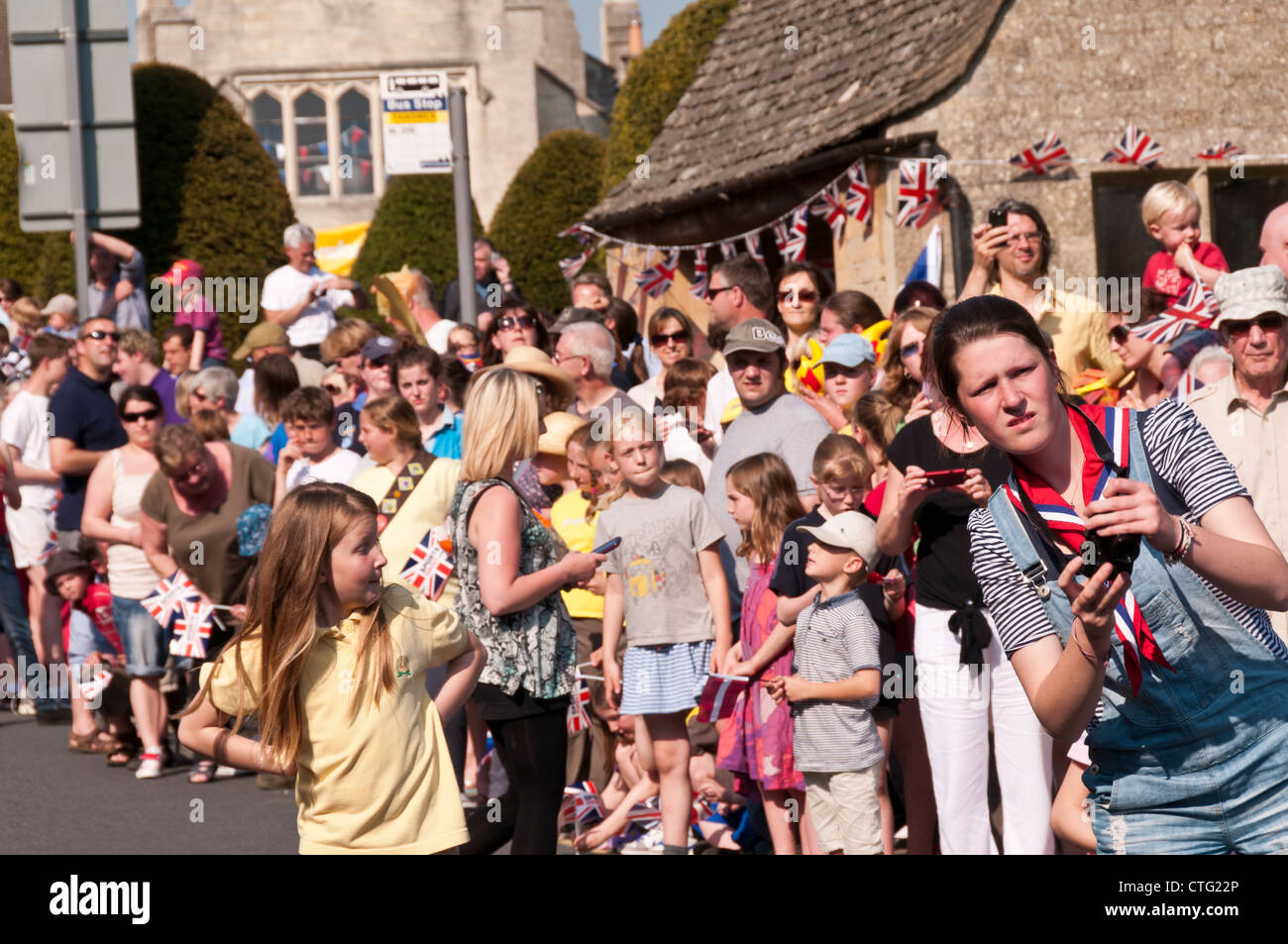 Crowd waiting for Olympic Torch bearer, Painswick, Gloucestershire, UK Stock Photo