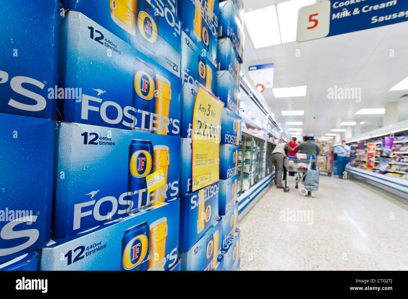 Boxes of Fosters stacked up in aisle, Tesco Supermarket, UK Stock Photo
