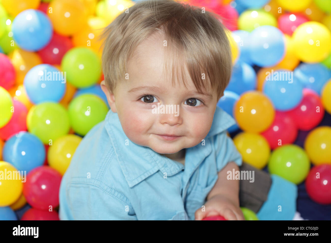 Baby playing in multi coloured balls Stock Photo