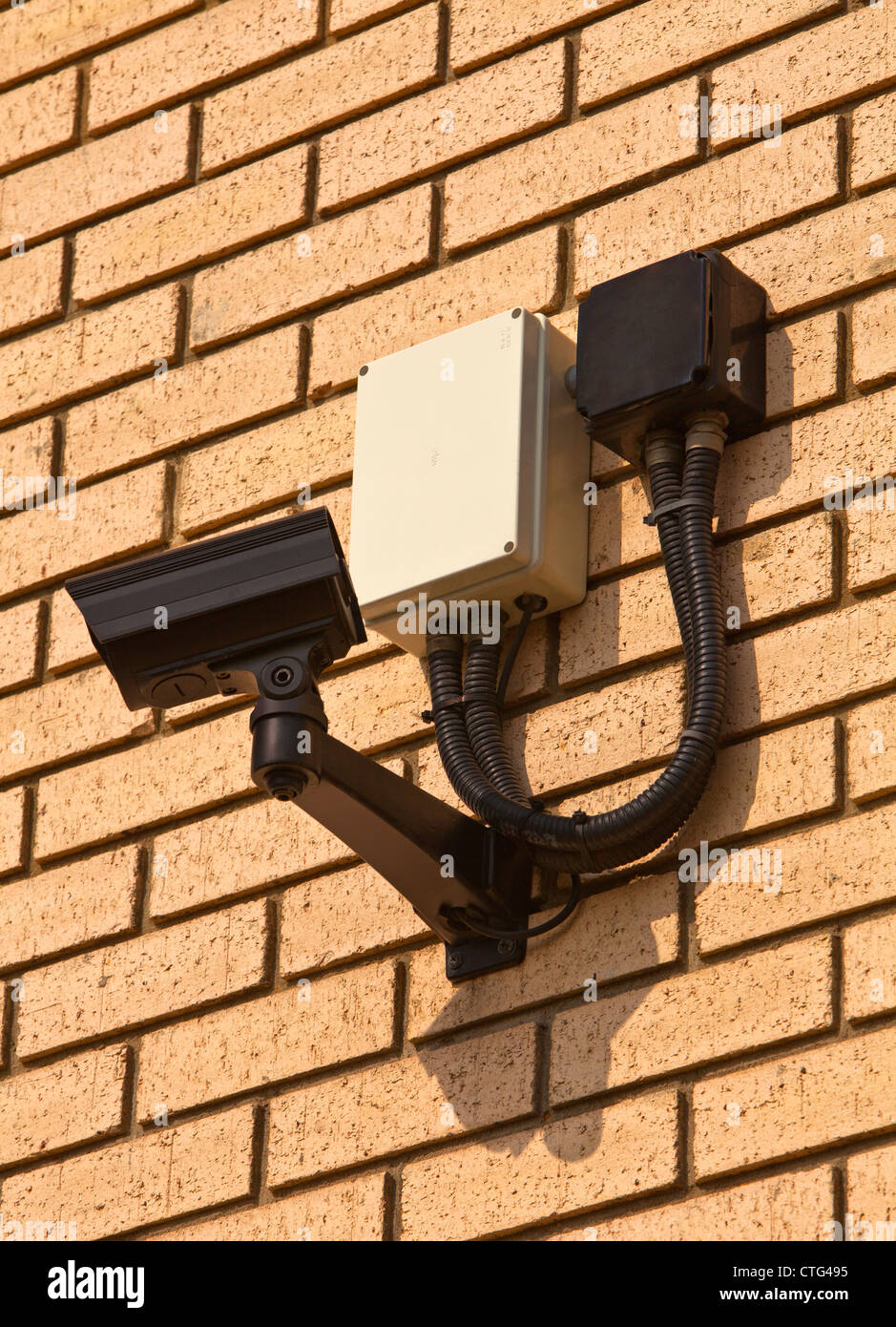 A wall mounted security camera facing left Stock Photo Alamy