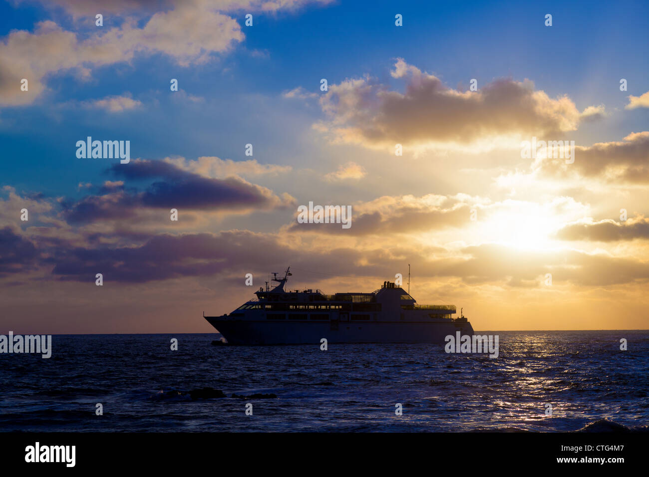 Tour ship in atlantic ocean, Sunset Stock Photo