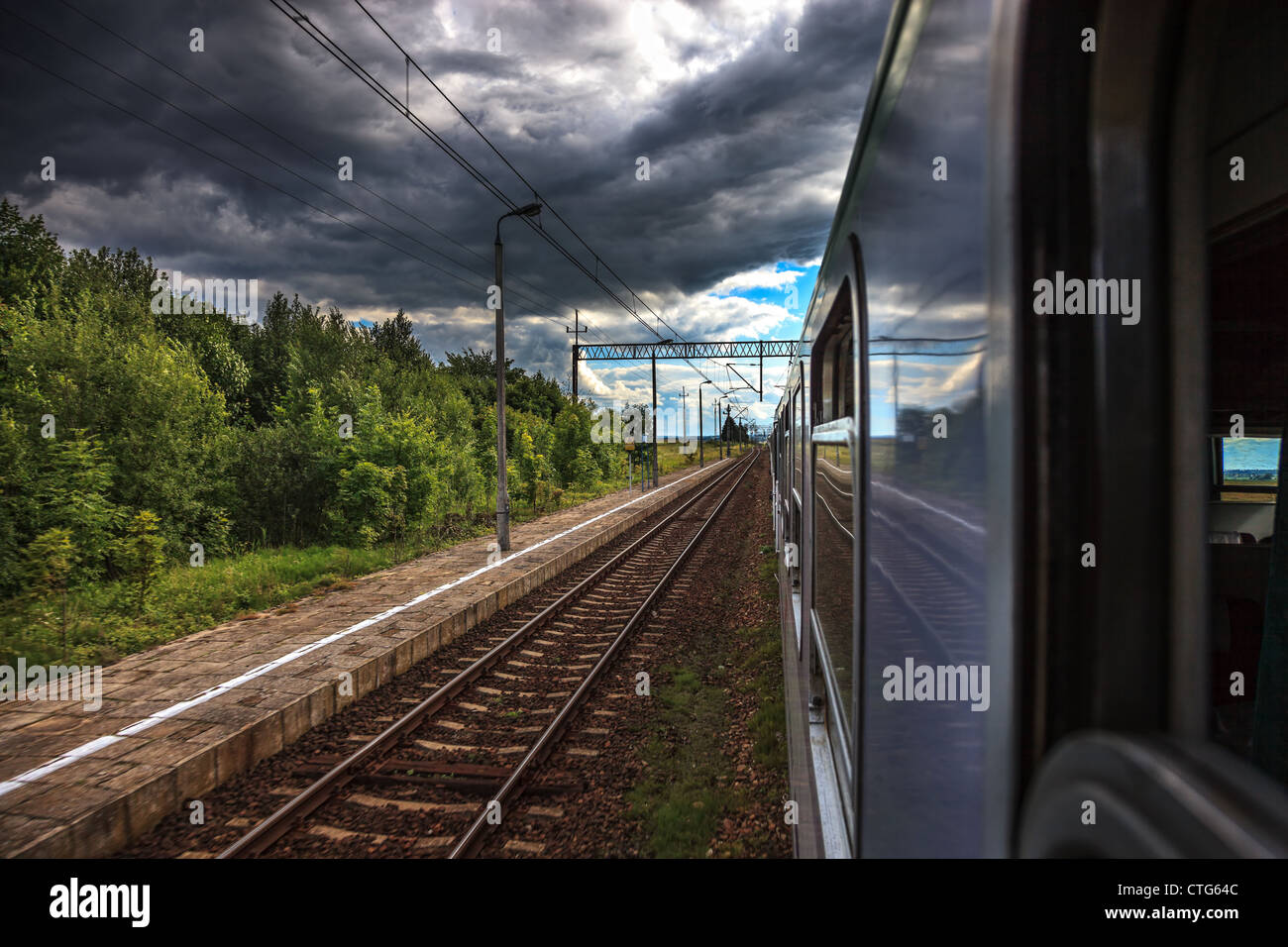 Dark rain clouds accompanying the train. Stock Photo