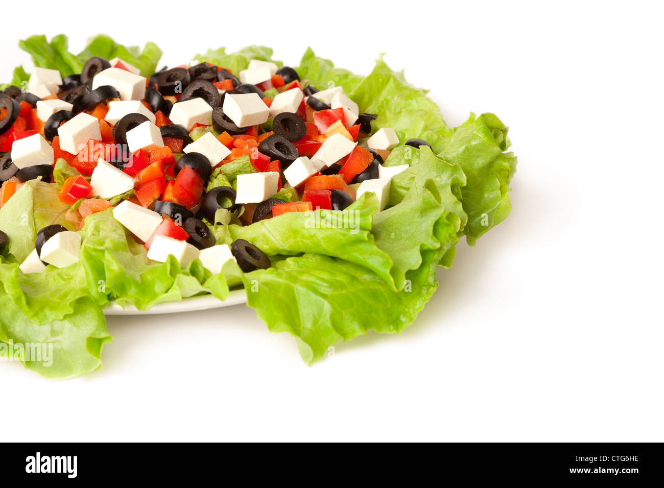 Picture of a greek salad on the plate isolated on white Stock Photo