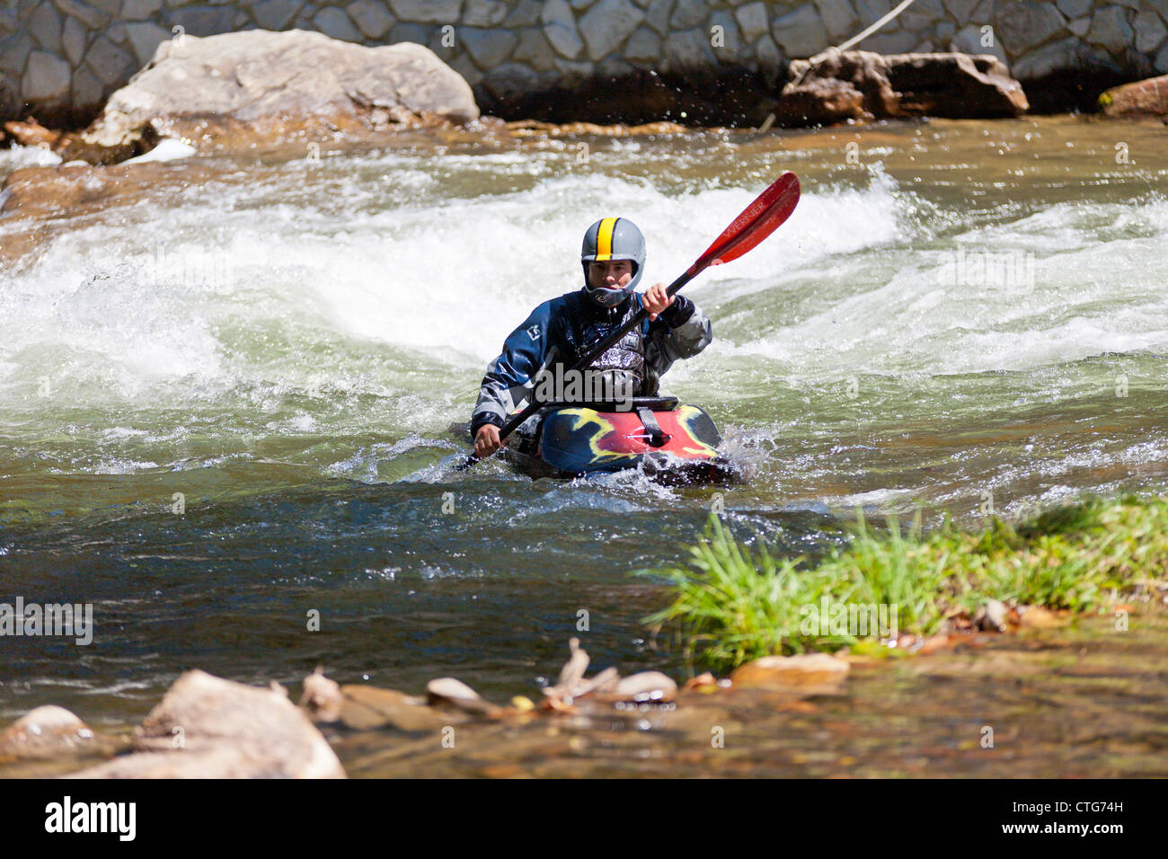 Whitewater kayaker maneuvering kayak in rapids at the Nantahala Outdoor Center in North Carolina Stock Photo
