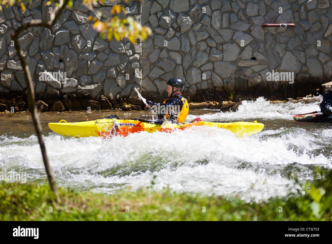 Whitewater kayaker maneuvering kayak in rapids at the Nantahala Outdoor Center in North Carolina Stock Photo